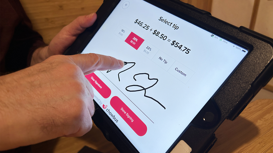 Customer using Chowbus handheld checkout system and choosing tip in Queens, New York. 