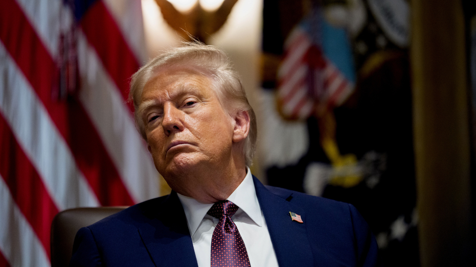 U.S. President Donald Trump listens in the Oval Office