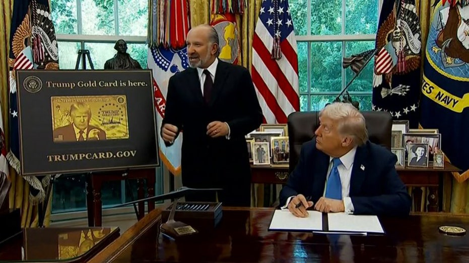 Commerce Secretary Howard Lutnick talks about the Trump Gold Card as President Donald Trump looks on in the Oval Office of the White House in Washington, D.C., Friday, Sept. 19, 2025.