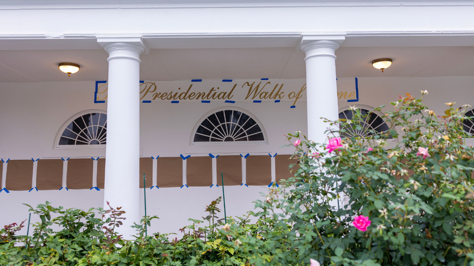 A banner reading "Presidential Walk of Fame' is seen along the White House colonnade