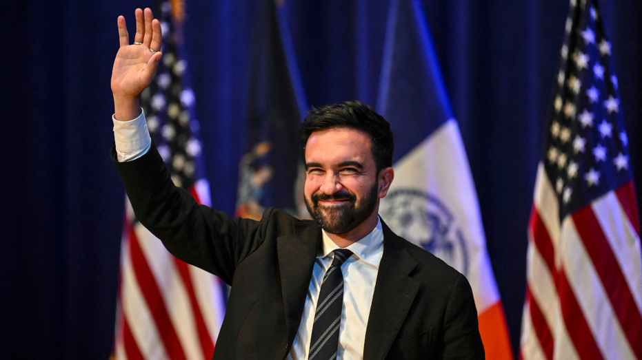 New York City Mayoral candidate Zohran Mamdani waves during a town hall