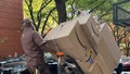 UPS delivery person with loaded hand truck on sidewalk in Manhattan, New York. - Fox News