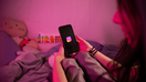 A teenager lying in bed while on Instagram. - Fox Business News
