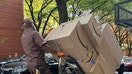 UPS delivery person with loaded hand truck on sidewalk in Manhattan, New York. - Fox Business News