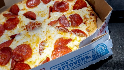 MIAMI, FLORIDA - JULY 21:  In this photo illustration, a Domino's pizza sits in a take-out box on July 21, 2025 in Miami, Florida. Domino’s reported second-quarter U.S. same-store sales growth of 3.4%, which is more than the estimated 2% increase.  (Photo illustration by Joe Raedle/Getty Images) - Fox Business News