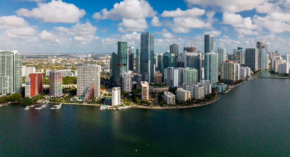 Miami skyline with sun and clouds