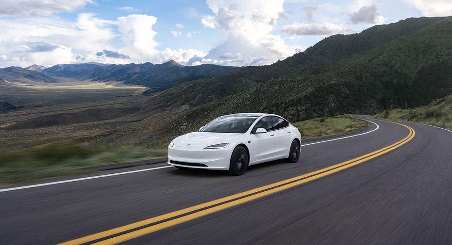 A Tesla Model 3 sedan on highway