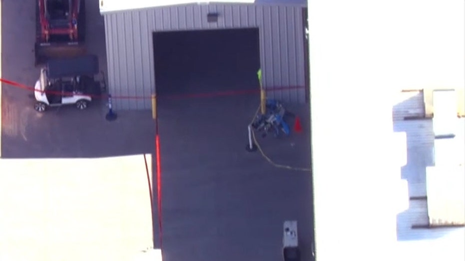 broken Amazon drone near commercial warehouse