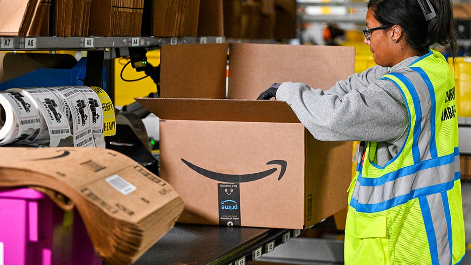Amazon worker packs delivery in warehouse