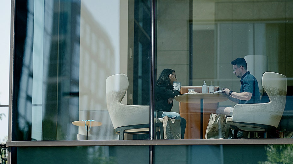 Two people sitting in chairs.
