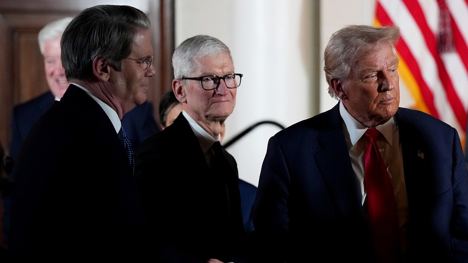 Apple CEO TIM Cook looks on as US President Donald Trump and Secretary of State Scott Bessent greet business leaders during a visit to the US Ambassador's residence on October 28, 2025 in Tokyo, Japan.