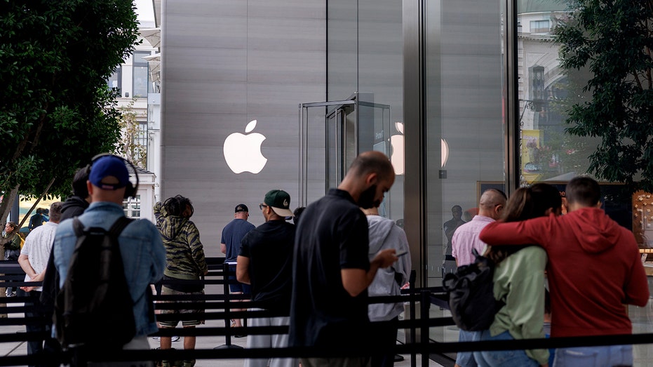 Customers wait outside Apple store in Los Angeles