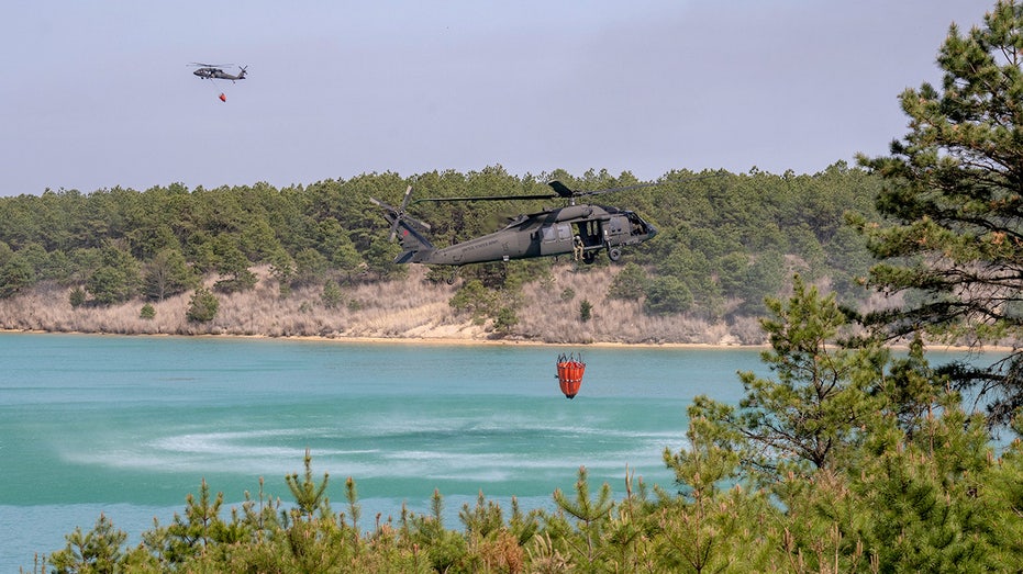 Black Hawk helicopters picking up water
