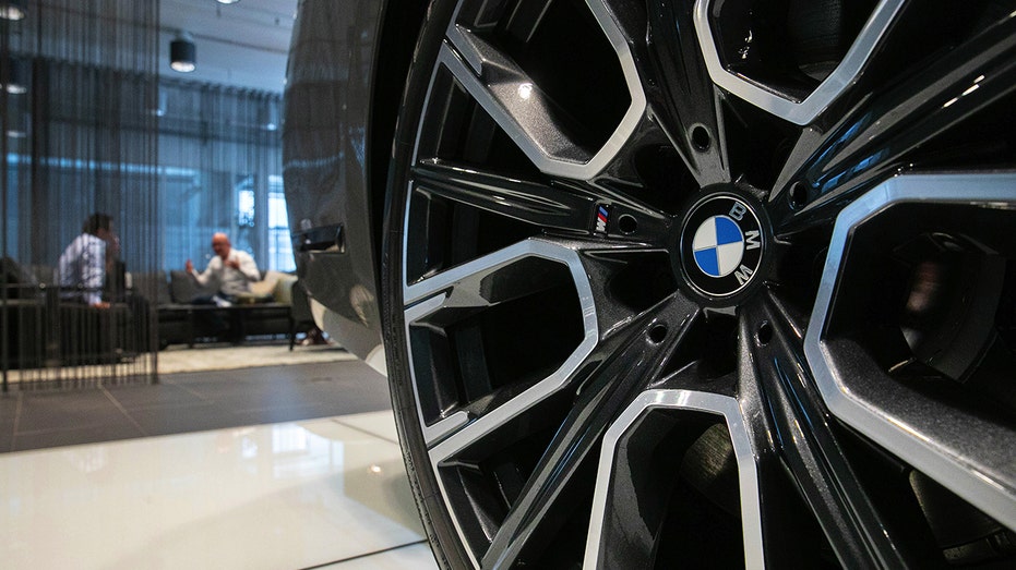 A BMW 745e Limousine wheel hub inside a BMW AG showroom.