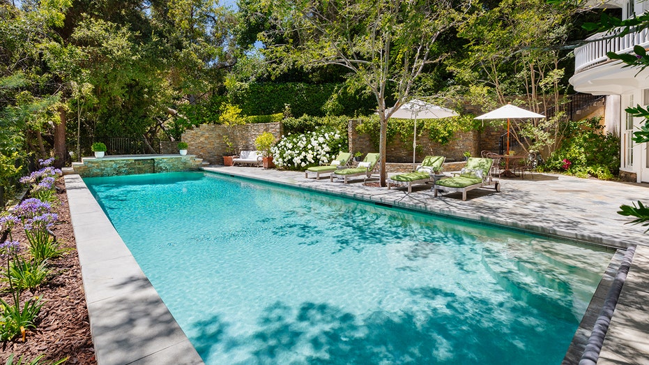 The background includes an external restaurant and a big swimming pool.