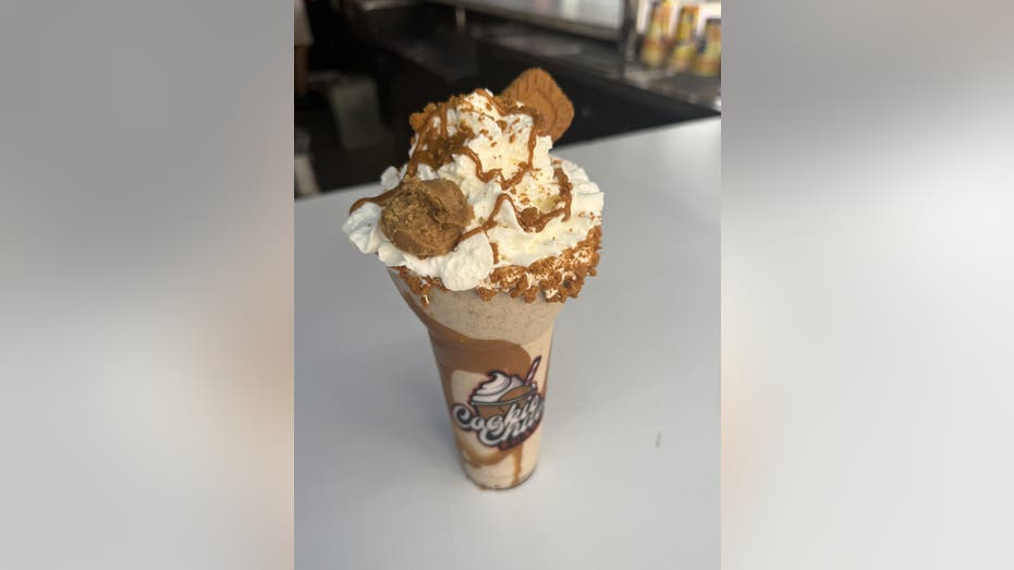 A cookie milkshake in a cup.