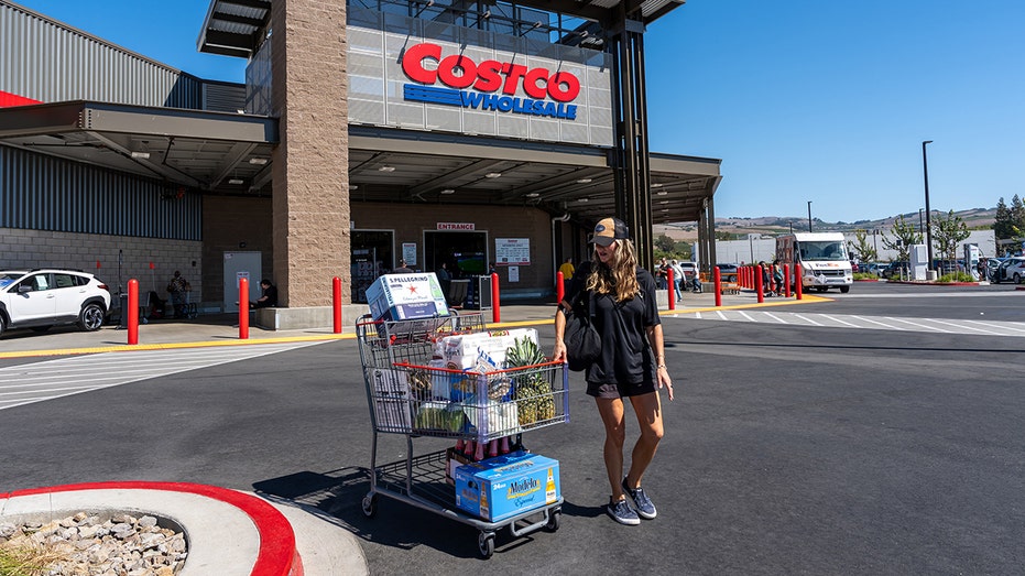 A shopper pushing a cart outside a Costco store in Napa, California.