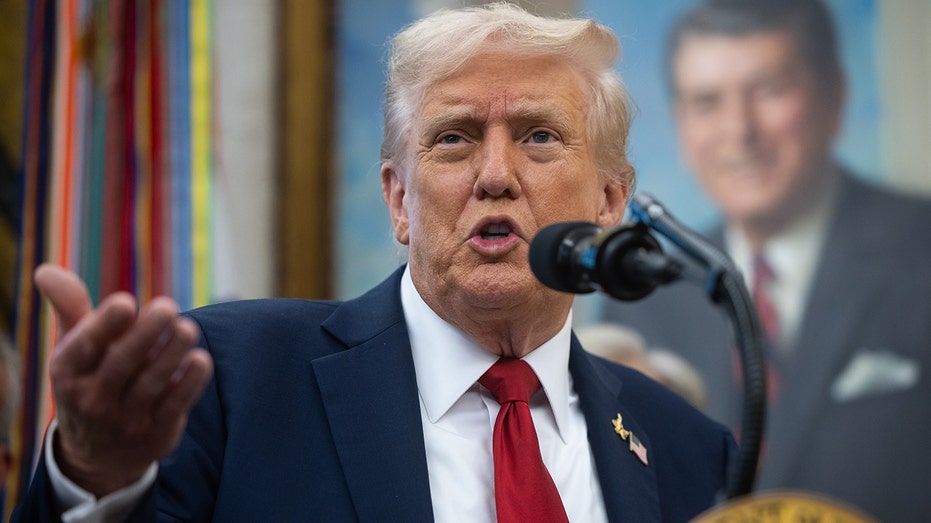 Trump gestures while speaking at the White House