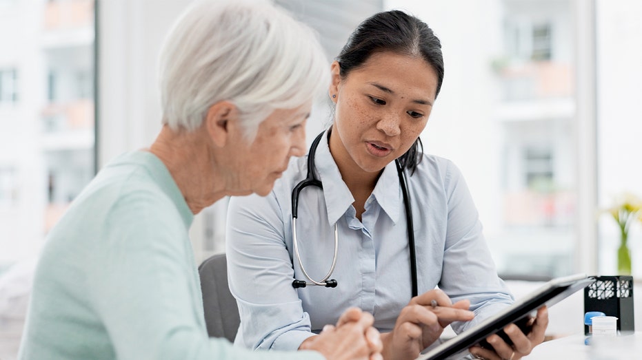 The doctor talks to an older patient