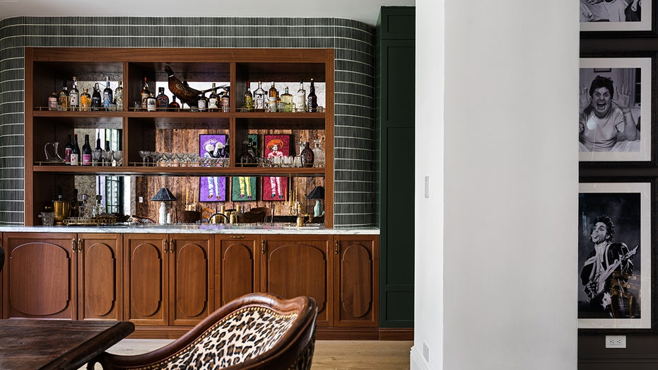 The living room leads to the formal dining room, which also includes a bar.