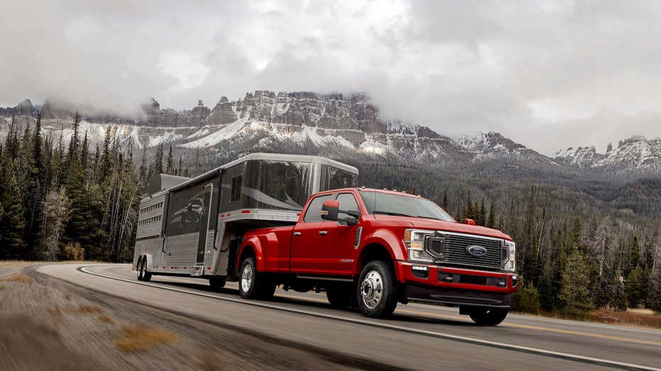 A Ford 450 superduty truck driving down the highway.