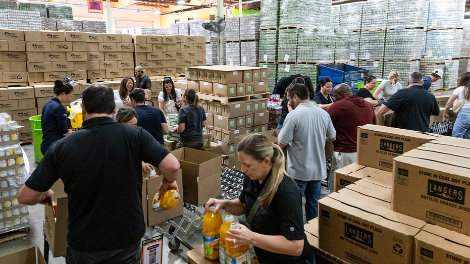 workers pack boxes at food bank