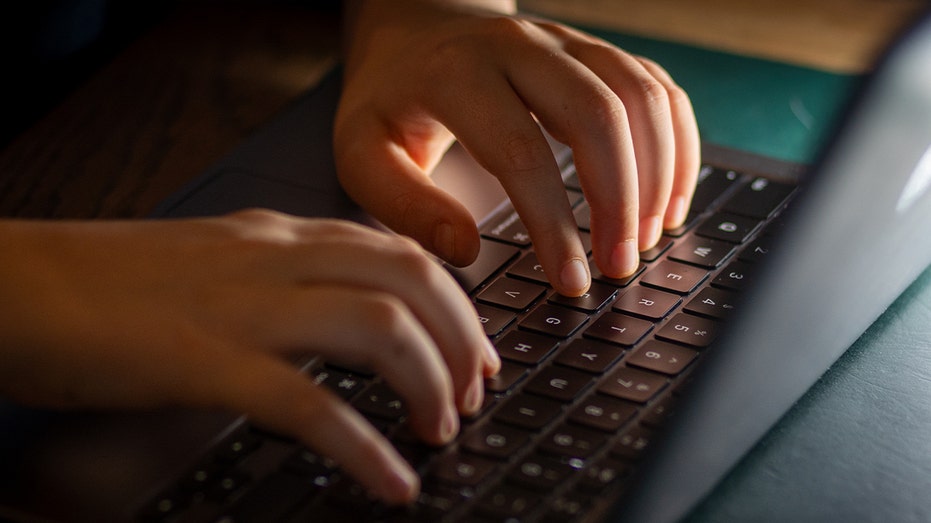 kid's hands on laptop