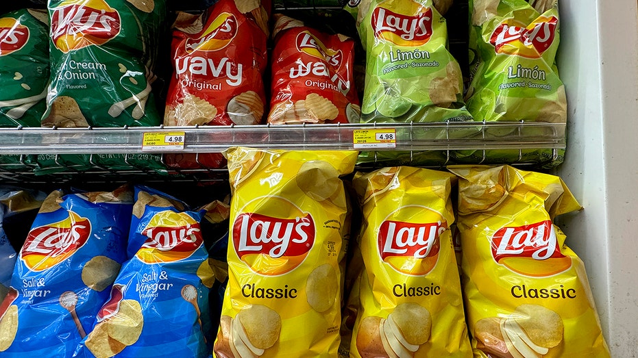 Bags of Lay's Classic potato chips are displayed in a grocery store