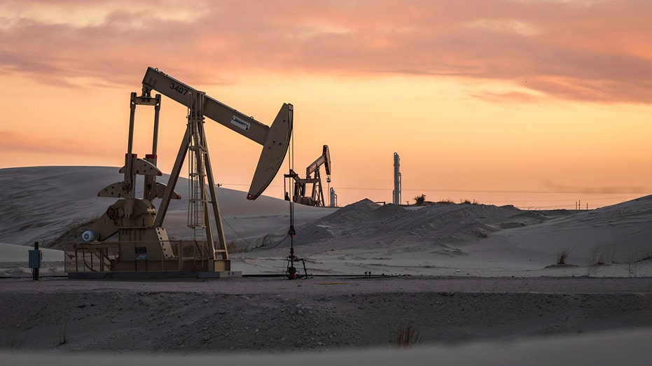 Permian Basin oil rigs with sunset in background