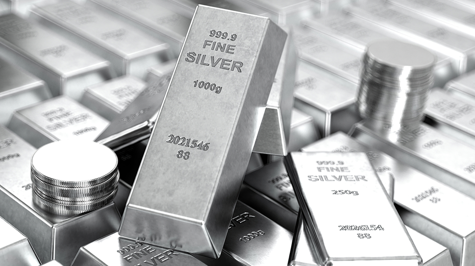 Silver bars and coins on a table