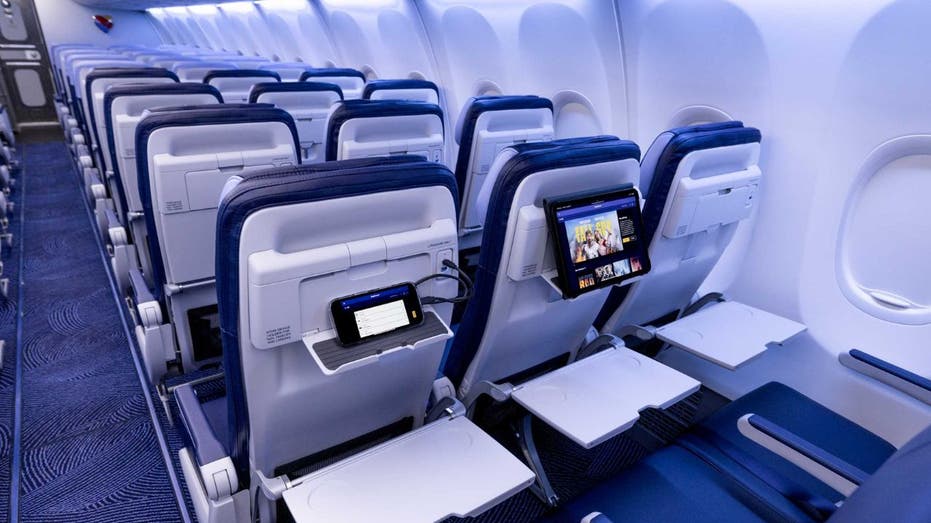 Close-up of Southwest Airlines RECARO R2 seatbacks with device holders and USB ports.