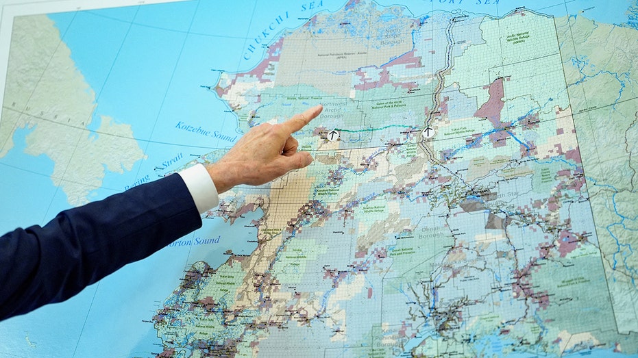 Point with a finger on the north map and Alaska in the Oval office