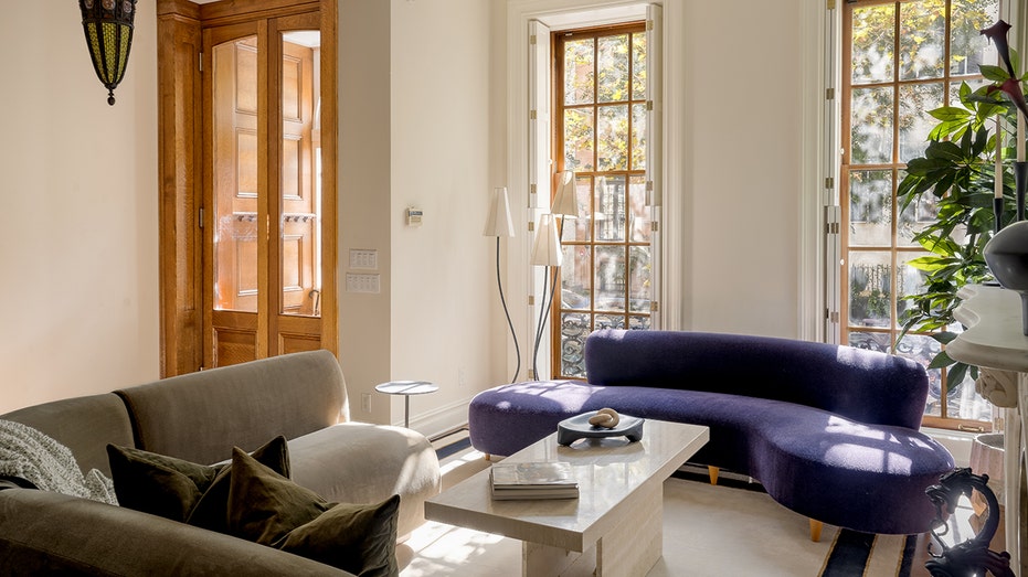 Living room with green and purple tiles and windows facing the outside.