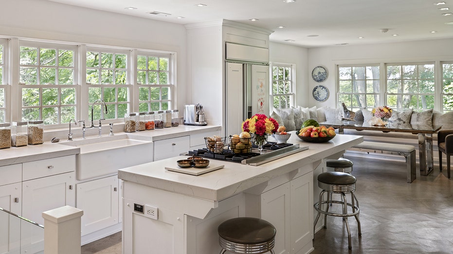 The kitchen features white cabinets and a breakfast nook.