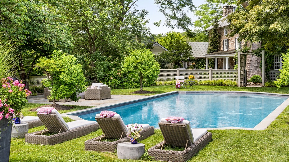 A swimming pool surrounded by grass.