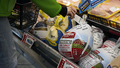 A customer checks the price on a Shady Brooks Farm frozen turkey at Ozzies Fresh Market, in the Brooklyn borough of New York City on Saturday, Nov. 23, 2024. - Fox News