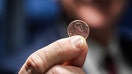 Treasurer of the United States Brandon Beach holds the last penny stamped at the U.S. Mint on Nov. 12, 2025 in Philadelphia, P.A. Beach pressed the final pennies at an event held at the facility. The pennies pressed bear a special 'Omega' and will not be put in circulation, but will be auctioned off.  - Fox Business News