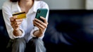 woman using smartphone Pay and hold credit card online shopping. - Fox Business News