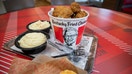 A bucket of fried chicken and side dishes are arranged for a photograph at a Yum! Brands Inc. Kentucky Fried Chicken (KFC) restaurant in Norwell, Massachusetts, U.S., on Thursday, July 25, 2019. - Fox Business News