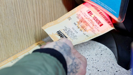 A customer scans a Mega Millions ticket to see if it is a winner at Circle K where the latest winning Mega Millions jackpot lottery ticket was sold, in Cottonwood, California, U.S. December 28, 2024.   - Fox Business News