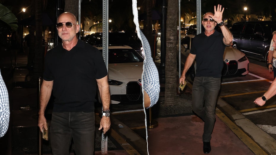 Bezos wearing a simple black shirt and jeans combo.
