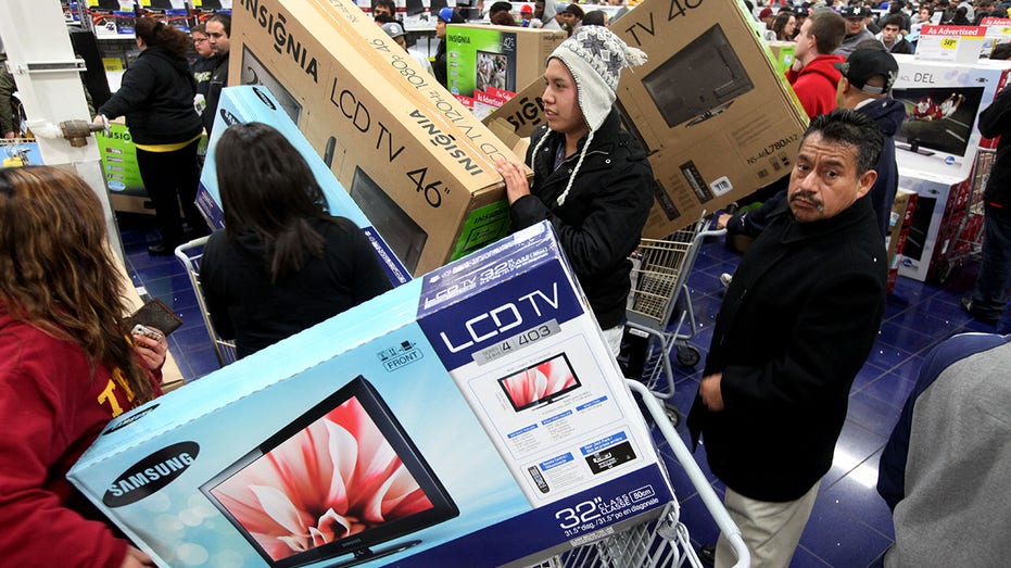 Black Friday shoppers carrying TVs