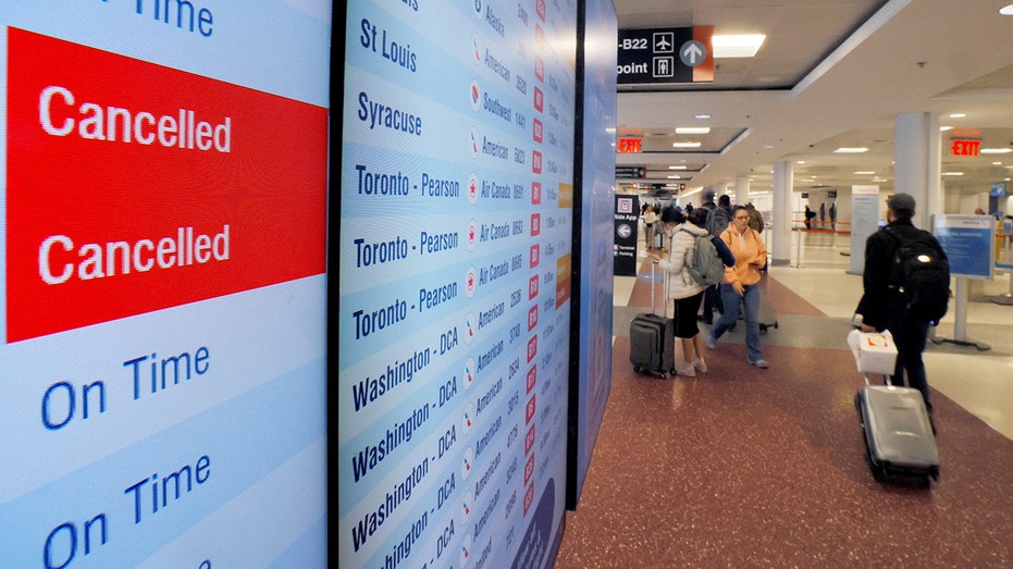 Board lists cancelled and delayed flights at the Boston Logan International Airport