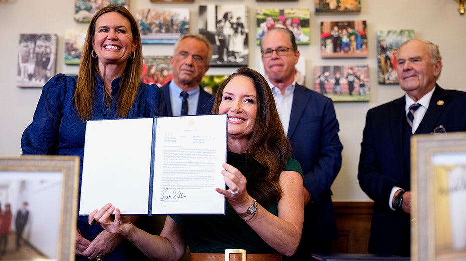 Agriculture Secretary Brooke Rollins signs a SNAP food choice waiver at her USDA office, joined by federal and state officials.