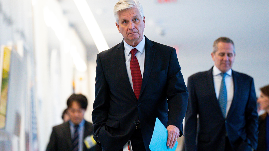 Federal Reserve Governor Christopher Waller walks the hallway of the Federal Reserve.