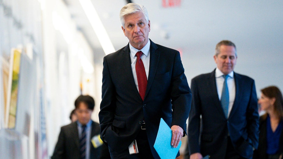 Christopher Waller, governor of the Federal Reserve, walks in the hallway of the Federal Reserve building