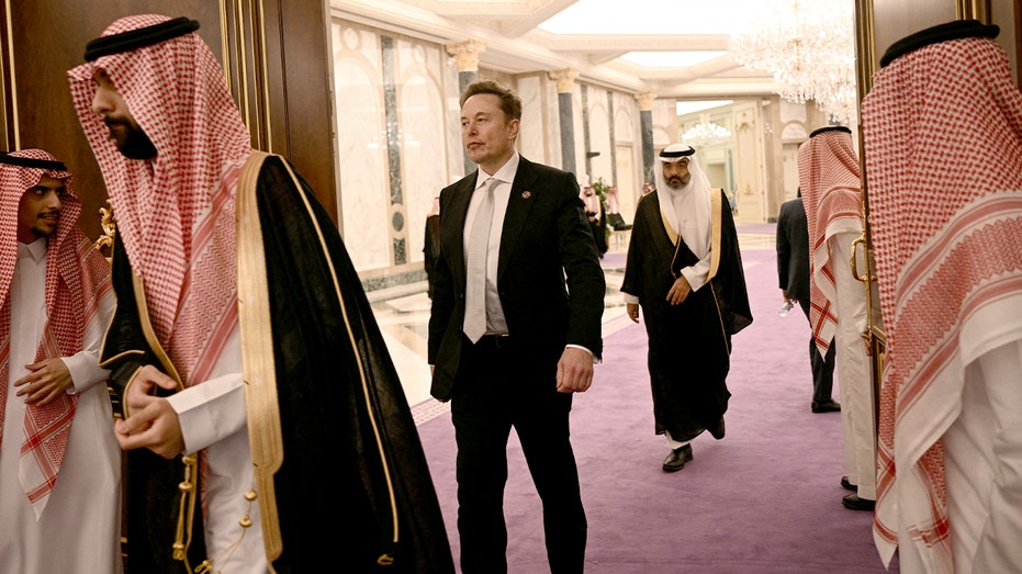 Elon Musk walks out of a meeting venue in Riyadh.