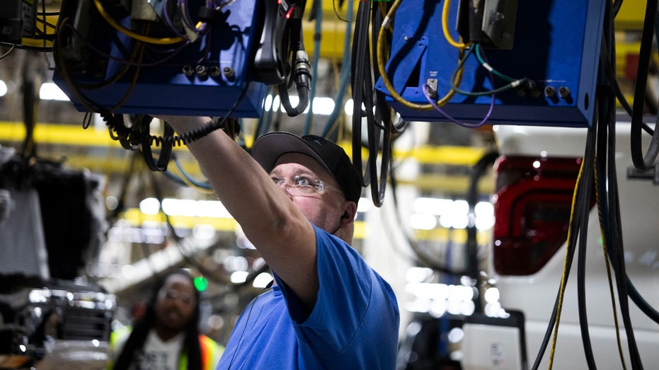 Employee working on an assembly line at a Ford plant in Michigan