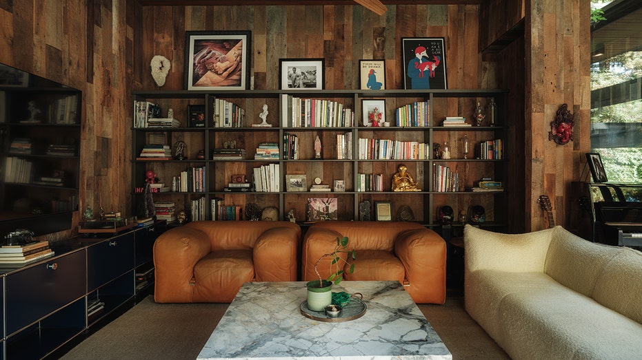 The home features a den with built-in shelves and a TV.