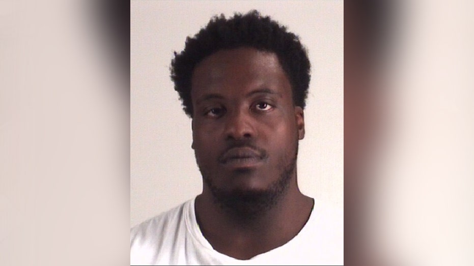 mugshot of man in white shirt